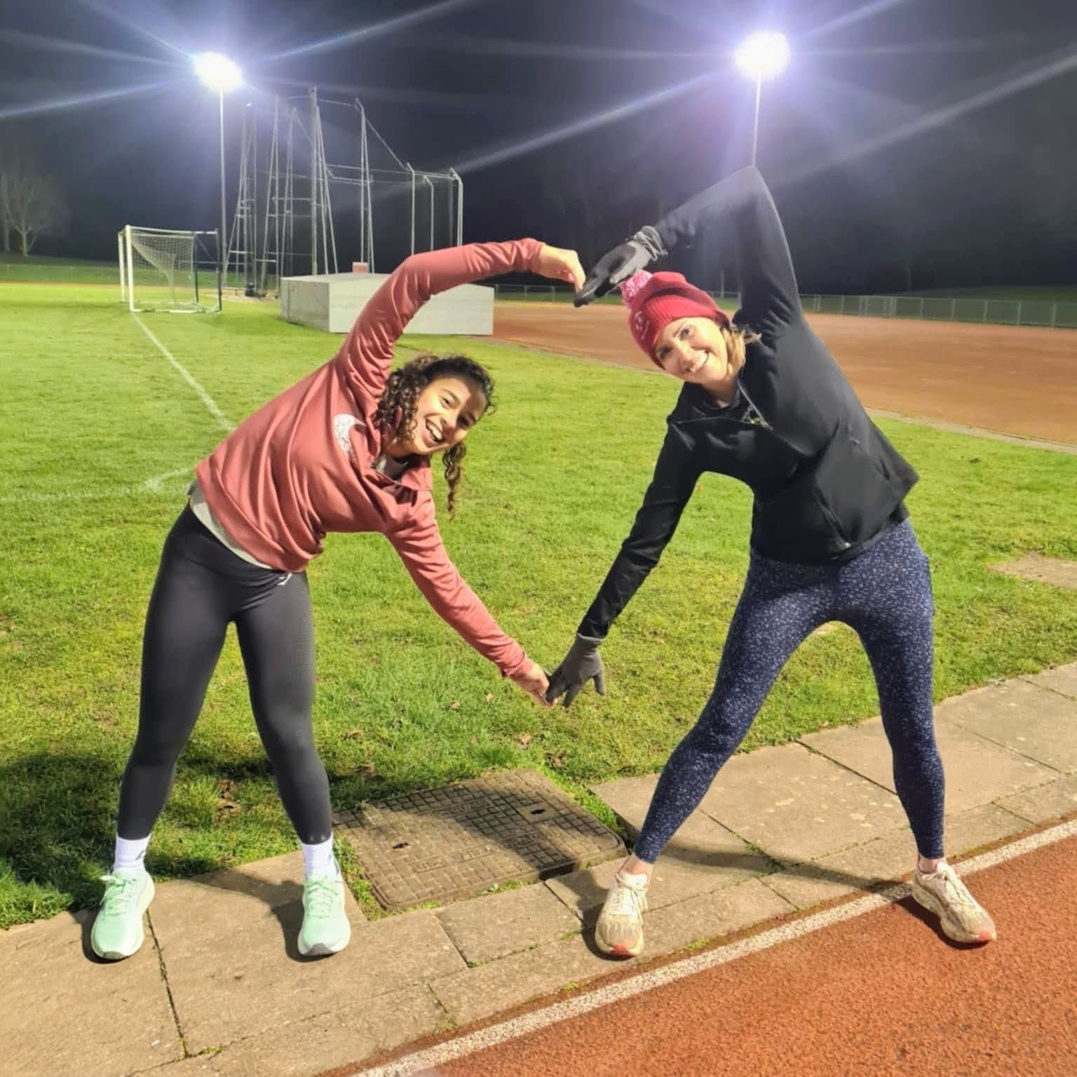 Two Ware Joggers runners stretching on the track