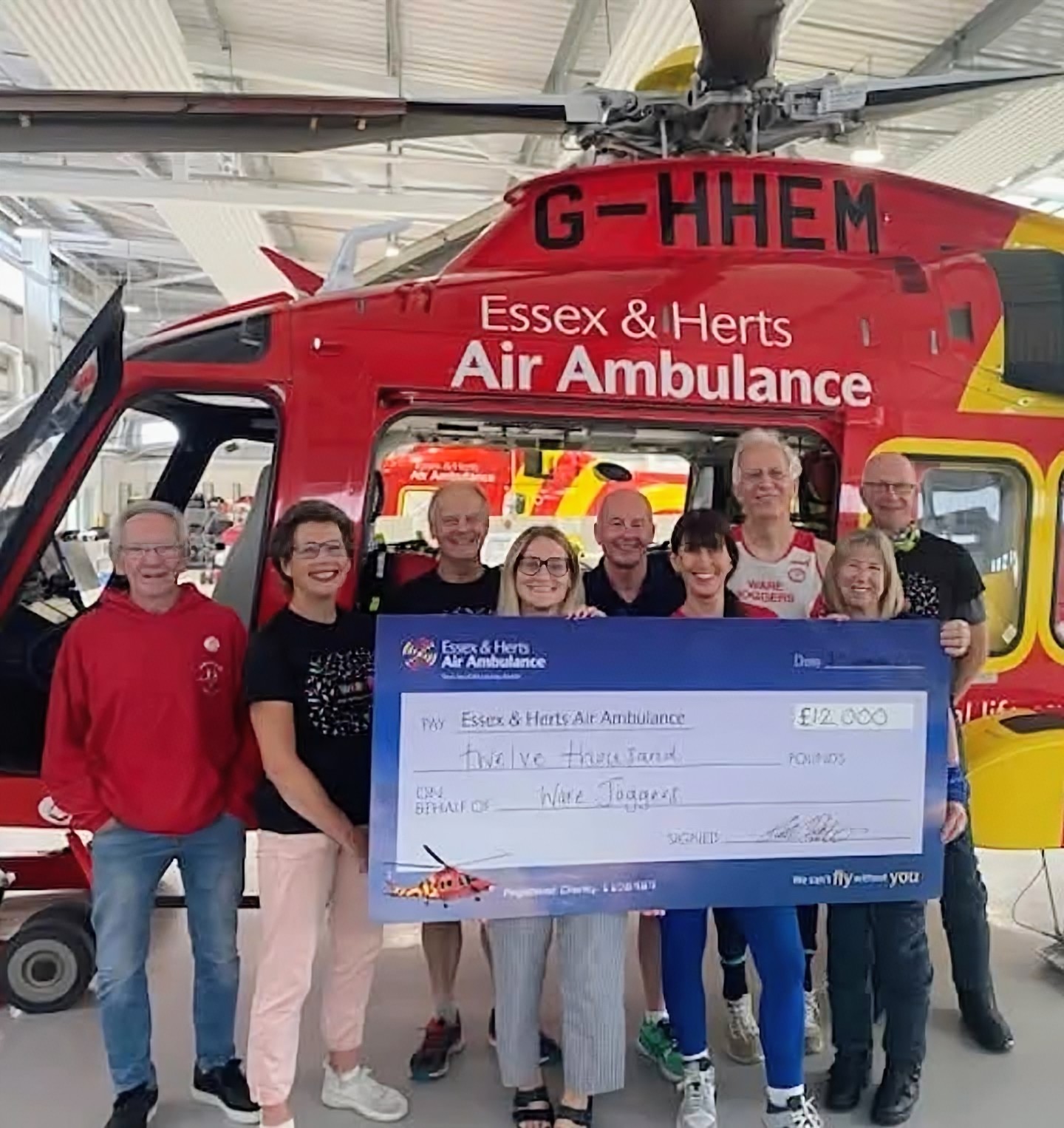 Ware Joggers members presenting a charity cheque