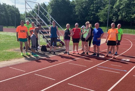 Wide-angle view of Wodson Park running track with athletes
